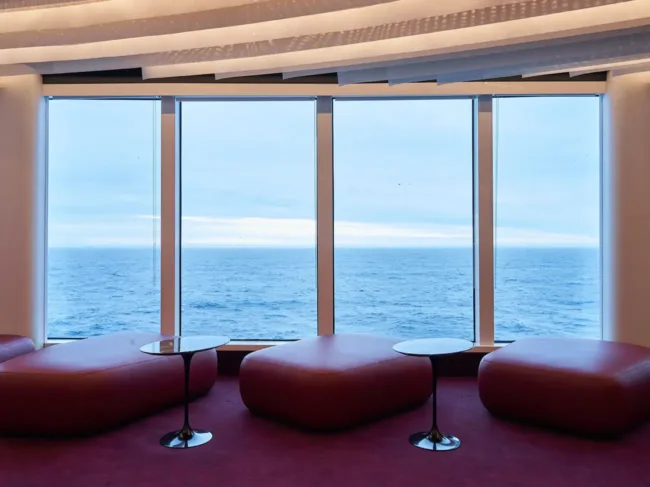 The Scene offers floor to ceiling windows with views of the ocean and seating