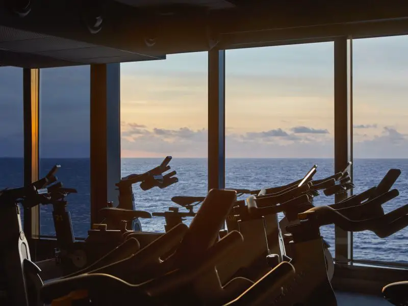 An exercise bike studio with a large window overlooking the ocean