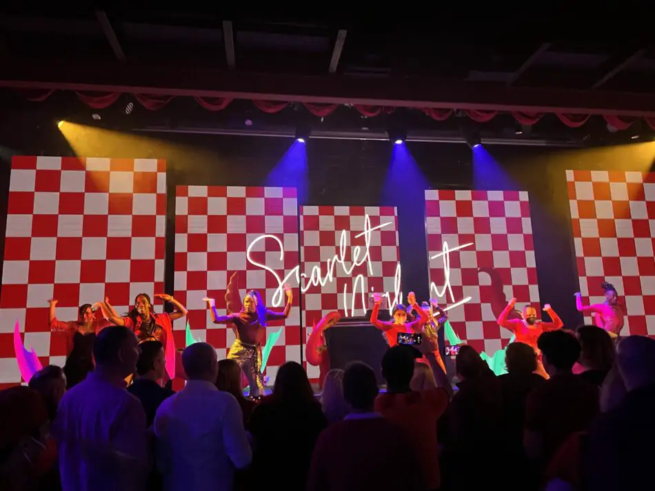 Scarlet Night on screen with dancers in front