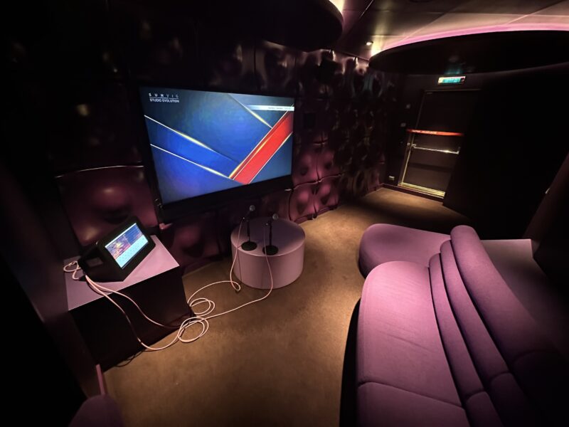 A private karaoke room with purple furnishings