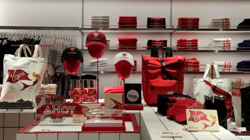 A shop with a number of Virgin Voyages branded items including hats and t-shirts