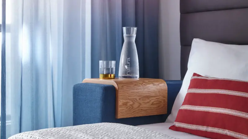 a bedside table with a glass decanter of water