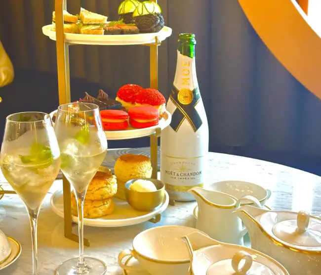 Glasses of champagne, tea and a tower of food