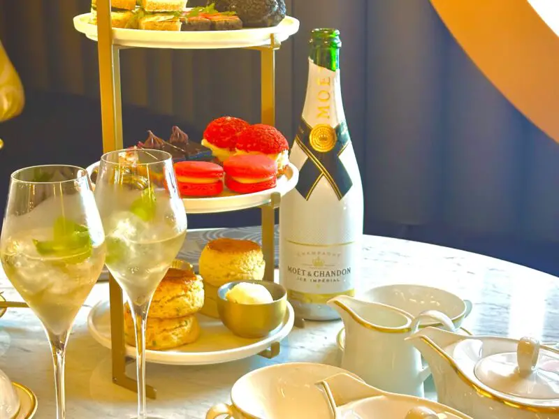 Glasses of champagne, tea and a tower of food