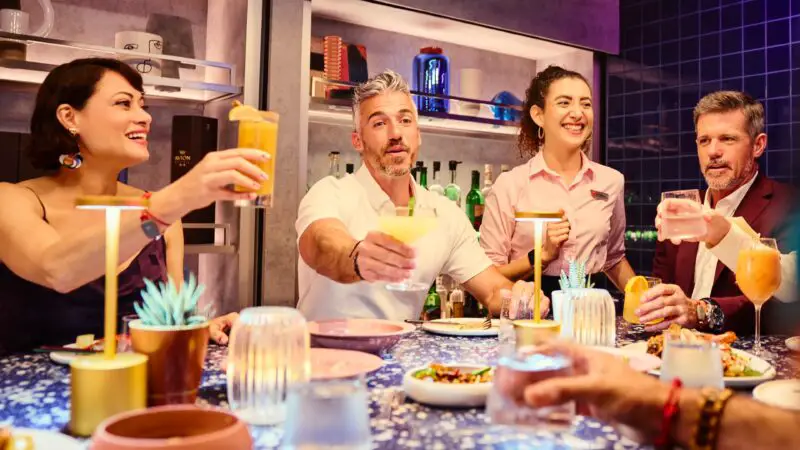 People toasting with glasses of margaritas at a Mexican restaurant