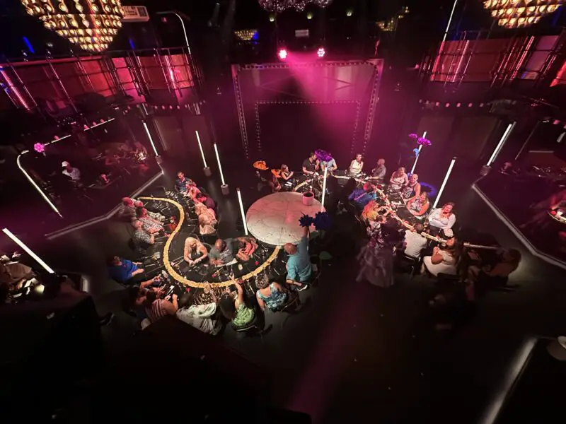 An s-shaped banquet table in a venue with club lighting