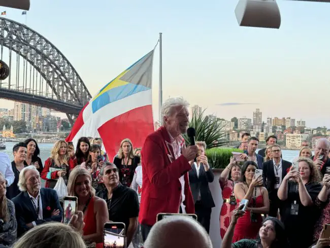 Sir Richard Branson delivering a speech alongside the Sydney Harbour Bridge