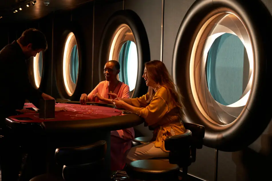 Two women playing a game at a table in the Casino