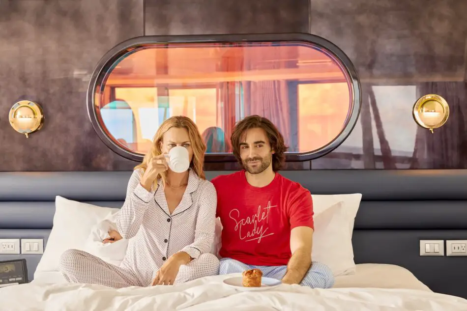 A couple enjoys breakfast in bed in the Brilliant Suite