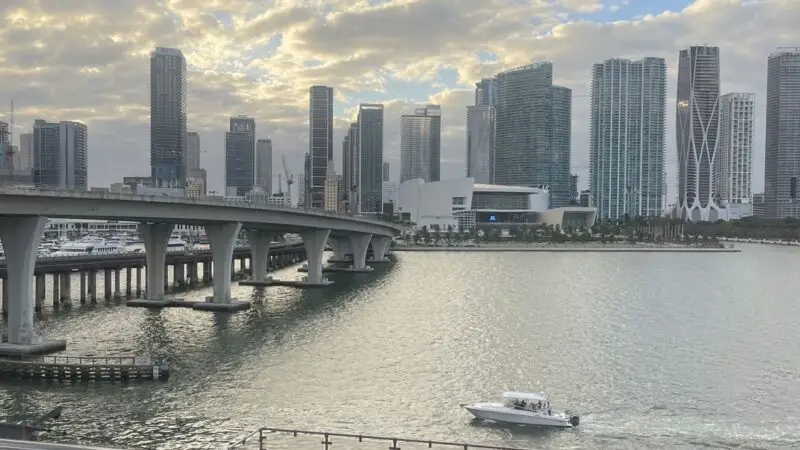 Balcony view from the Valiant Lady cruise ship showing a city skyline across the water