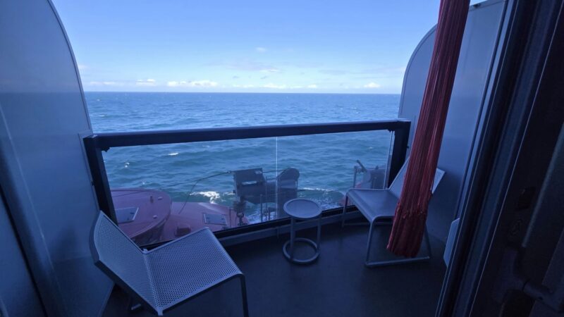Cruise ship balcony cabin on Virgin Voyages with ocean view