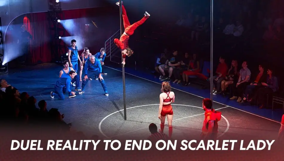 Pole routine on circular stage with blue-clad performers and a red-clad aerialist