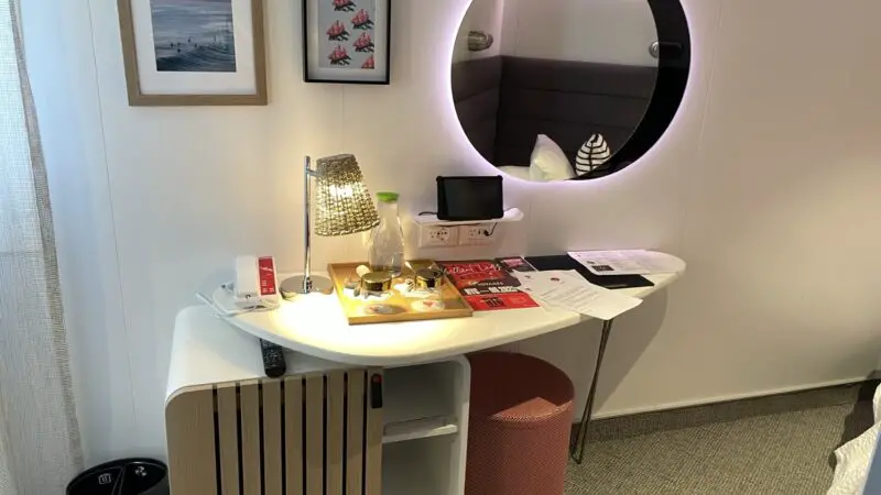 Virgin Voyages cruise ship cabin desk with round backlit mirror