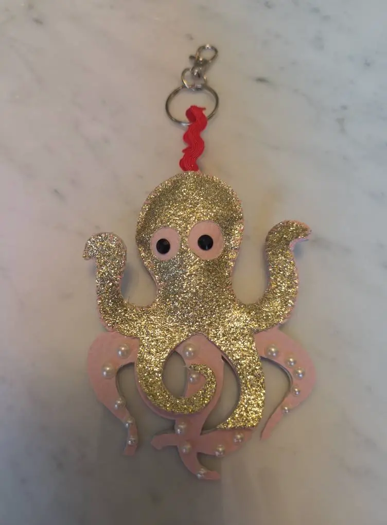 Glittery gold octopus keychain with pink tentacles and pearl beads