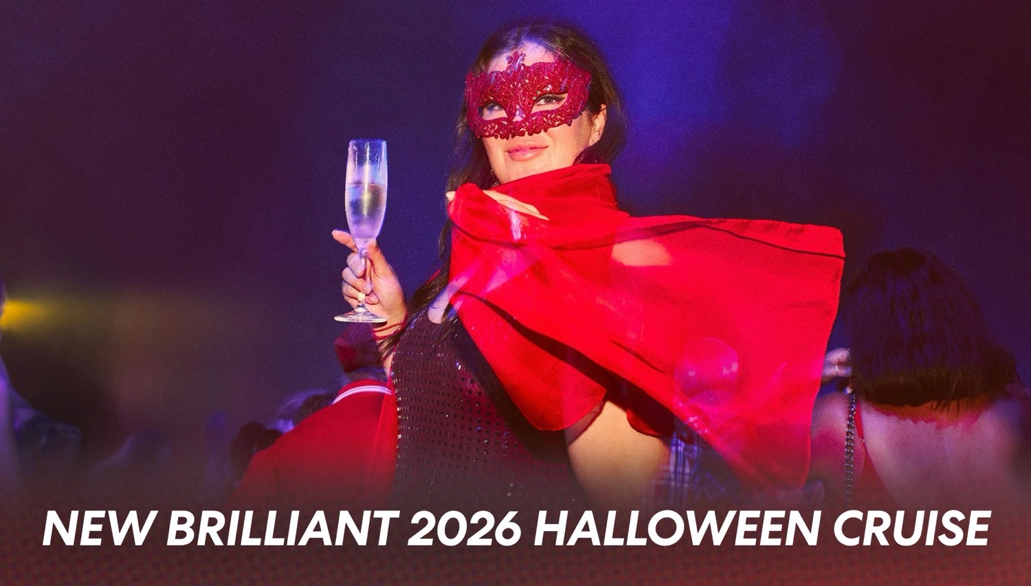 Woman in a red masquerade mask and cape raises a champagne glass at the New Brilliant 2026 Halloween Cruise