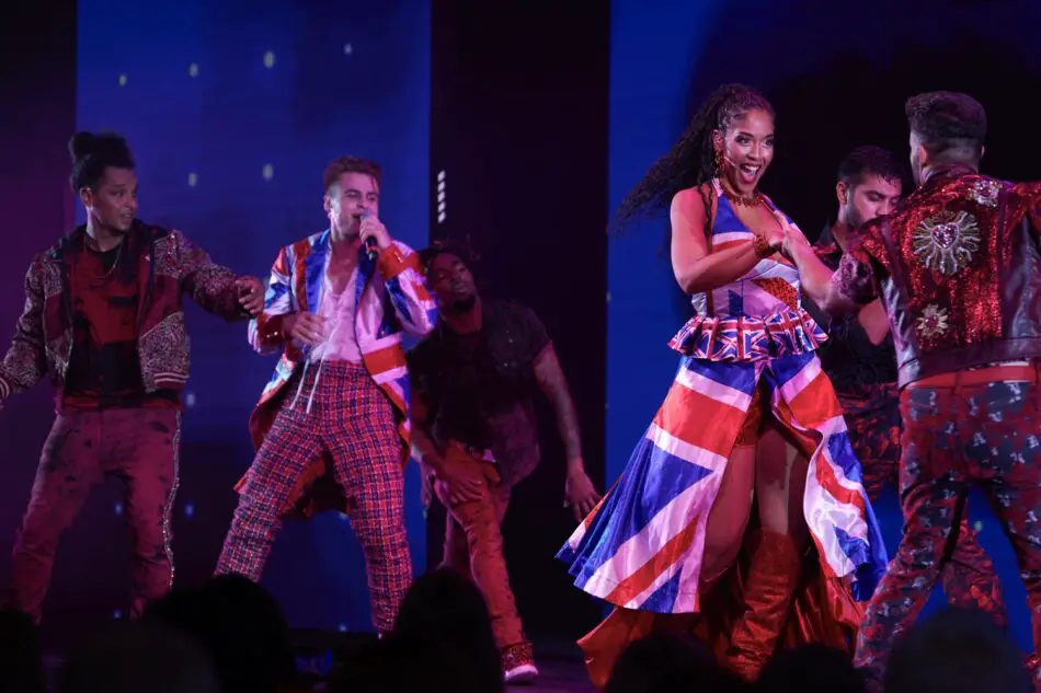 Performers in Union Jack themed outfits perform on a Virgin Voyages cruise ship