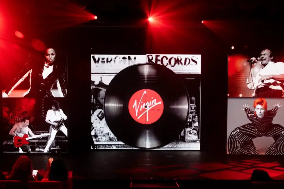 Virgin Records stage featuring a large vinyl record graphic and red lighting