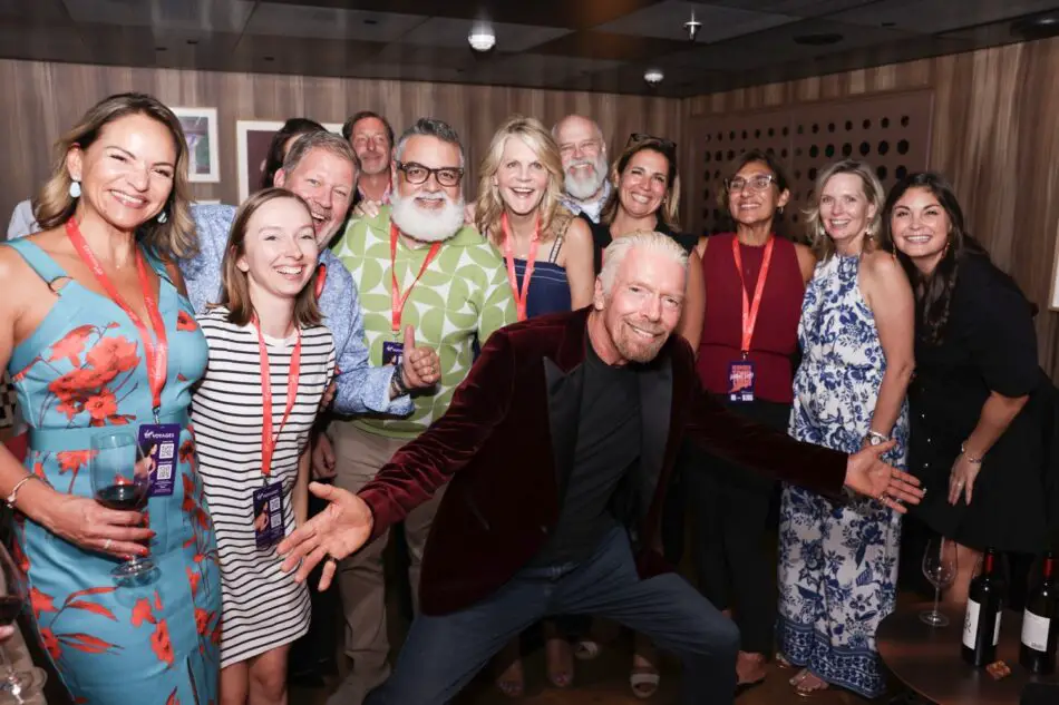 Group of guests posing for a photo on a Virgin Voyages cruise ship