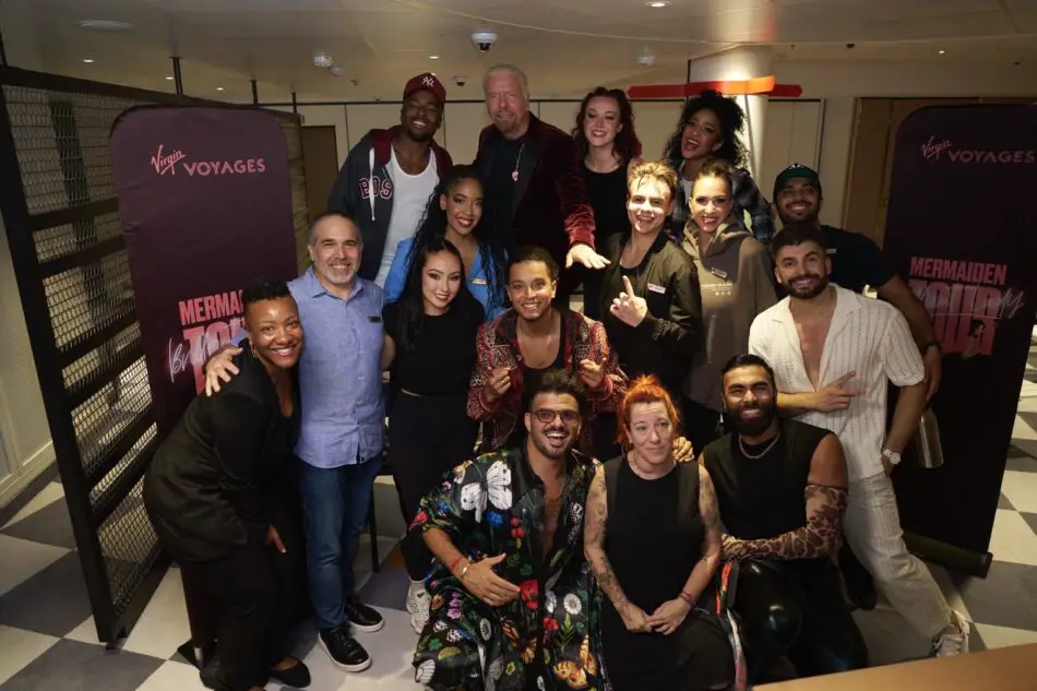 Diverse group of performers posing backstage at a Virgin Voyages event