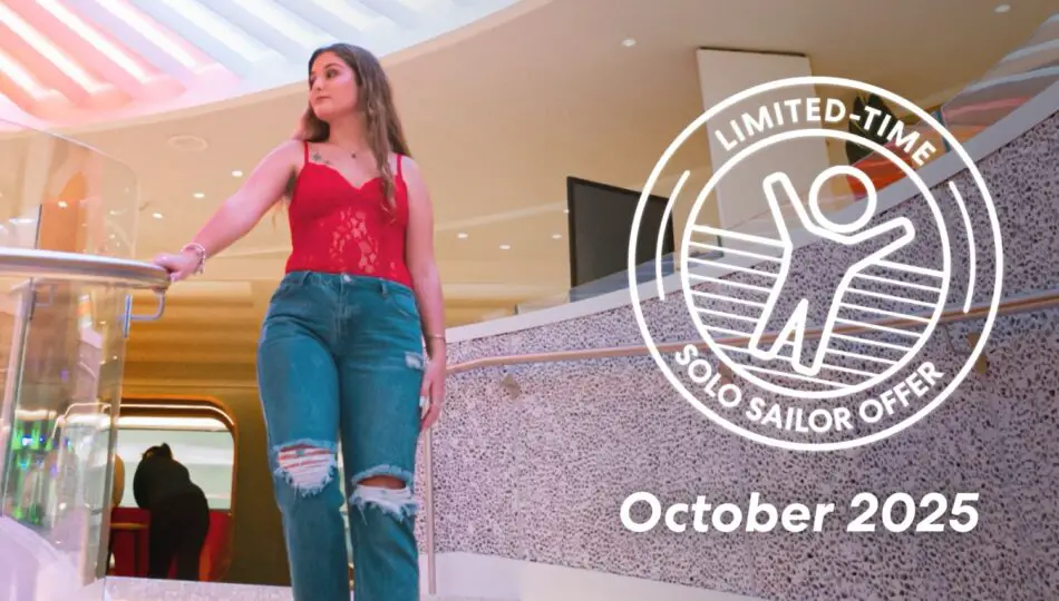 Woman in red top and ripped jeans in a Virgin Voyages cruise ship atrium