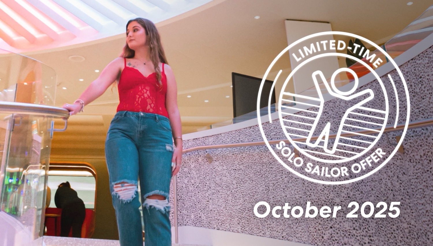 Woman in red top and ripped jeans in a Virgin Voyages cruise ship atrium