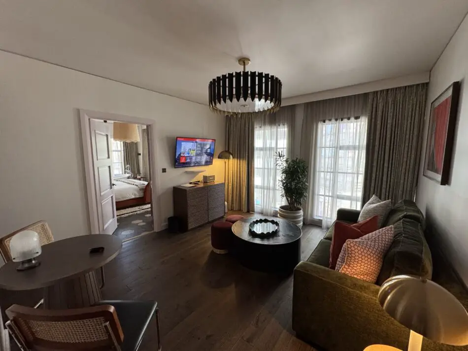 Living area of a Virgin Hotels with sofa and large windows