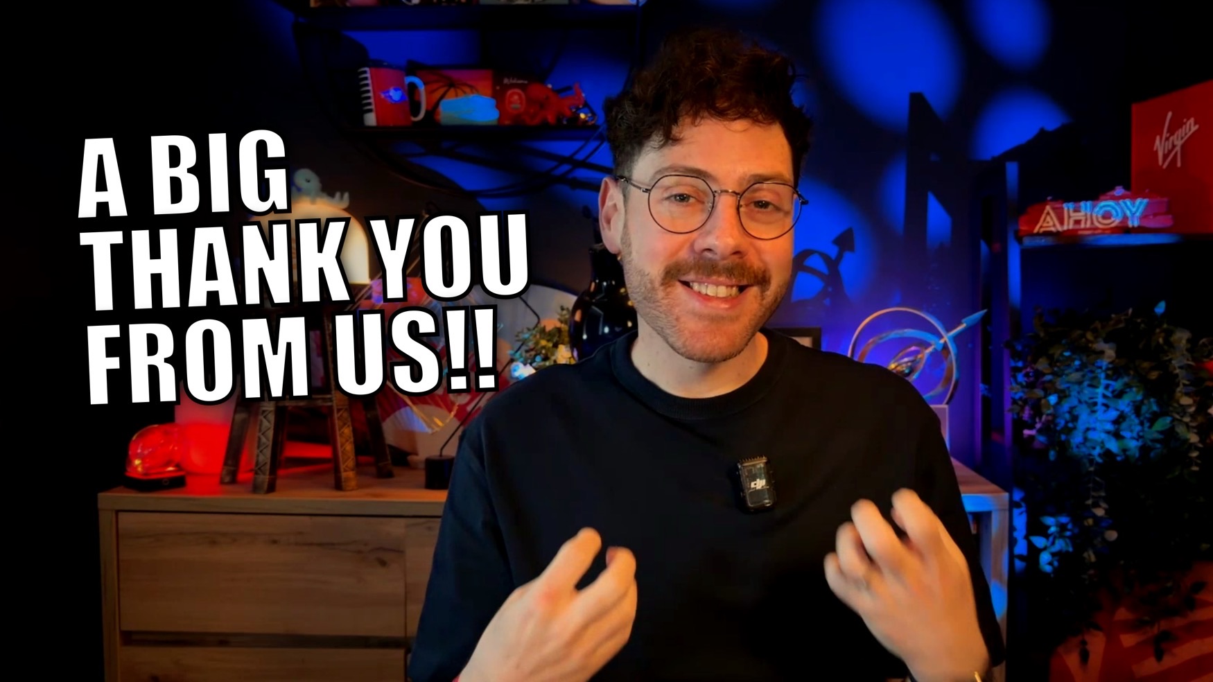 Smiling man in a blue-lit studio with large white text A BIG THANK YOU FROM US!!