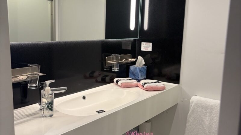 Virgin Voyages cruise ship cabin bathroom with sink and mirror