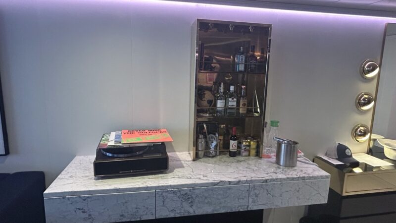 Cabin vanity with glass-front minibar on a Virgin Voyages cruise ship
