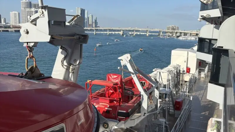 Deck view on a Virgin Voyages cruise ship with red lifeboats