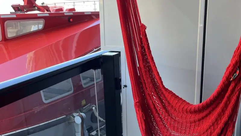 Red woven hammock in a Virgin Voyages cruise ship cabin