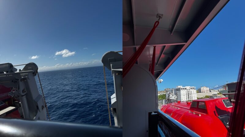 Sea view from a Virgin Voyages cruise ship deck with a red lifeboat