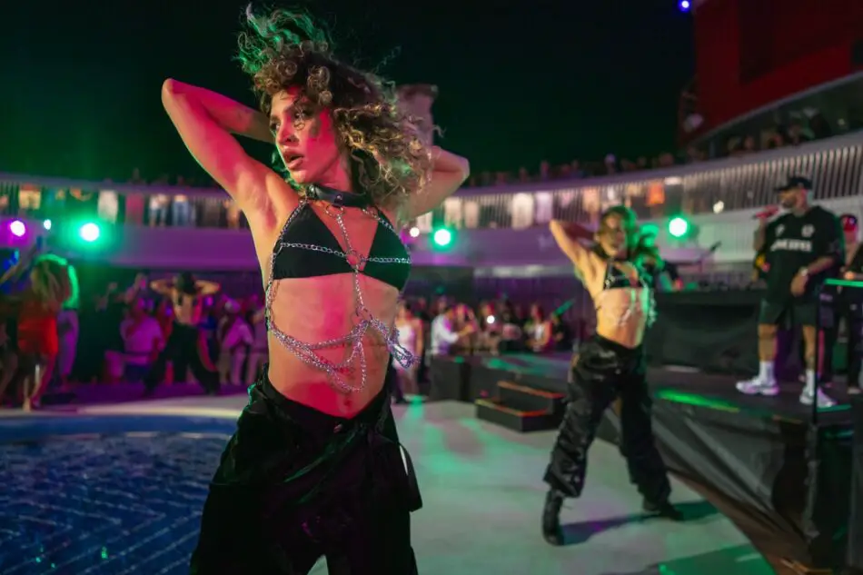 Dancers perform on a Virgin Voyages cruise ship poolside stage at night