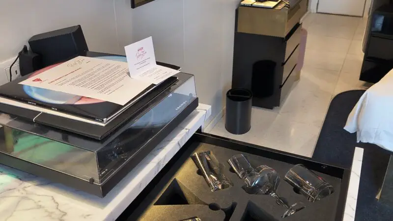 Glassware arranged in an open drawer in a Virgin Voyages cruise cabin 12255Z
