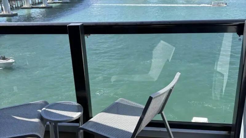 Balcony seating on a Virgin Voyages cruise ship with city skyline view