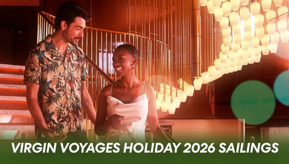 Two guests chat in a warmly lit Virgin Voyages cruise ship lobby