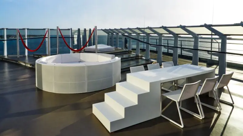 Outdoor lounge with circular white seating on a Virgin Voyages cruise ship deck