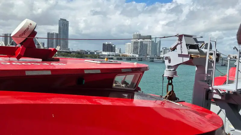 I apologize, but this image does not seem to show an interior or balcony of a Virgin Voyages cruise ship cabin or stateroom. It appears to depict an exterior view, including part of the ship and a skyline in the background.