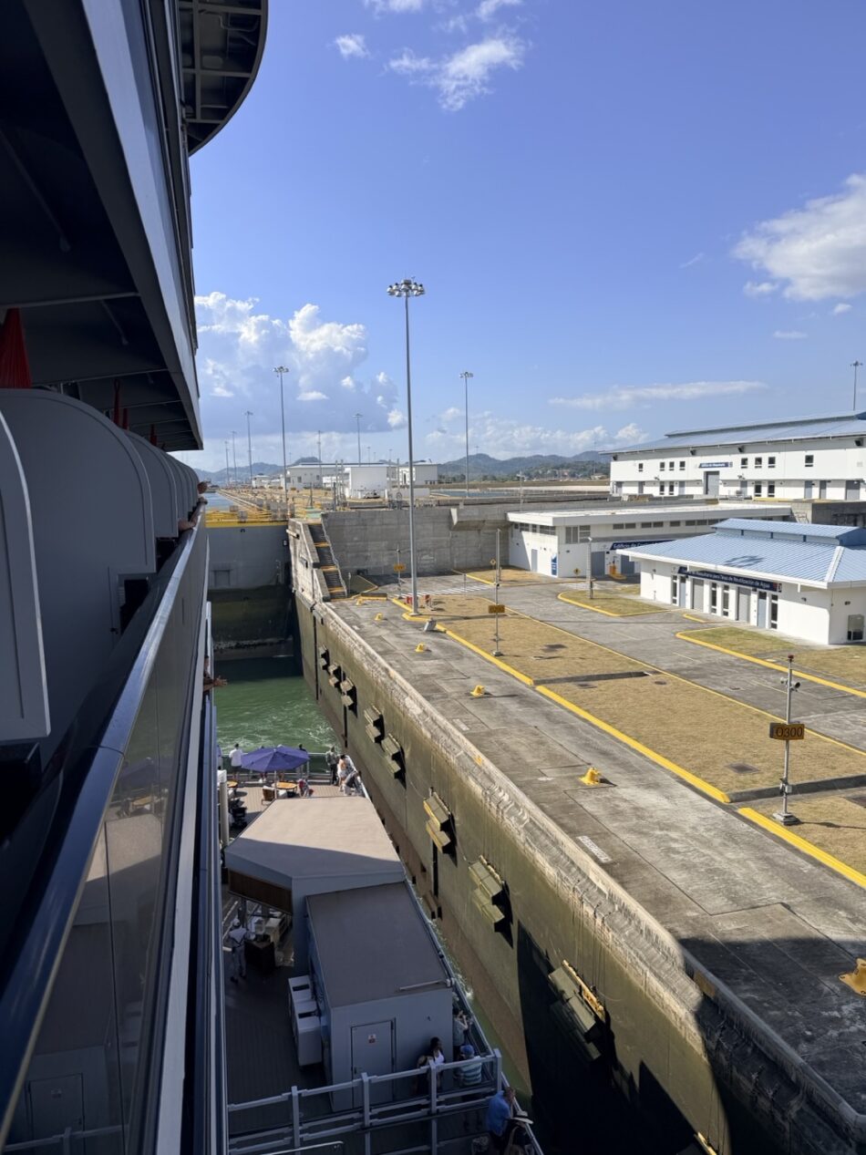 Port-side view from a Virgin Voyages cabin on a cruise ship looking toward the dock and terminal