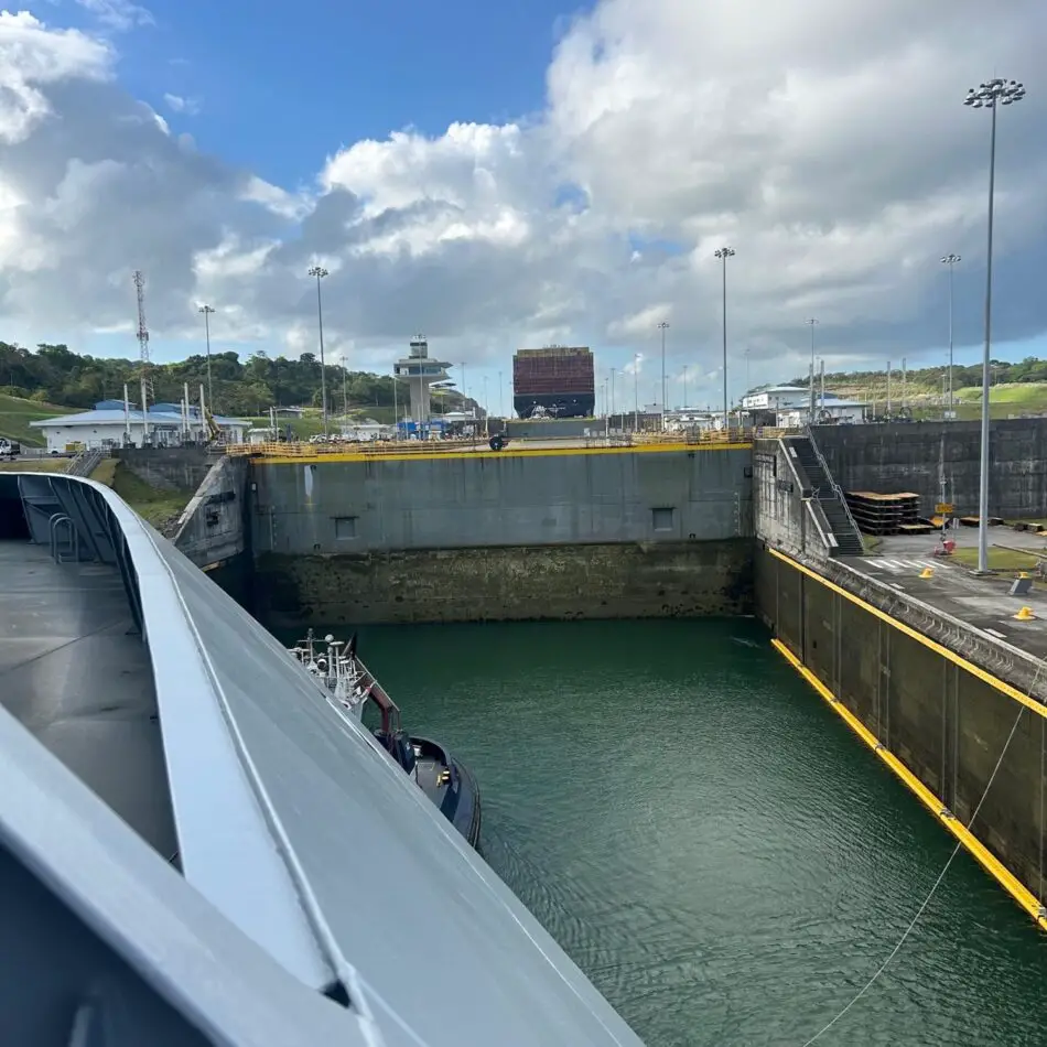 Cruise ship in a canal lock with yellow rails