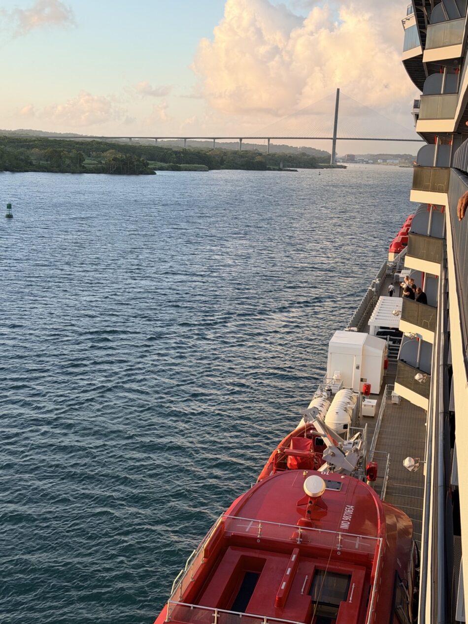 View from a Virgin Voyages cruise ship deck with red lifeboats and balconies