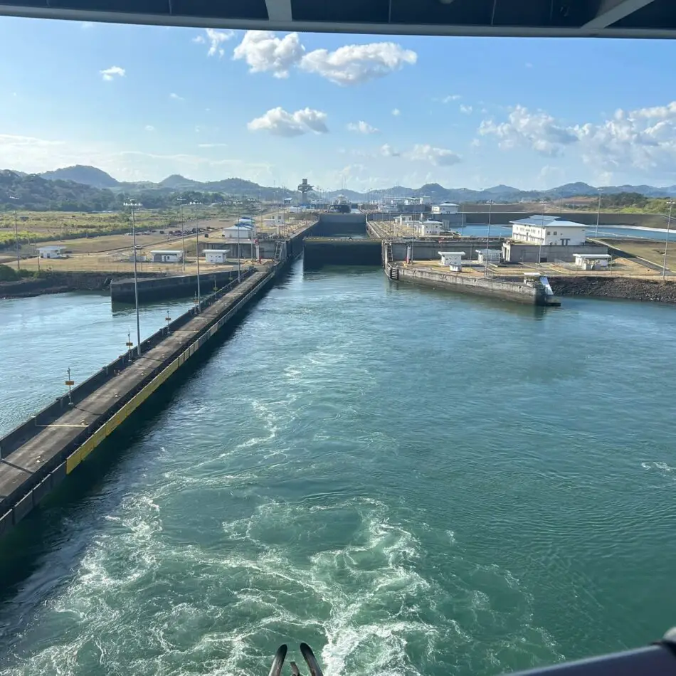 Lock chamber along a canal with water, gates, and buildings
