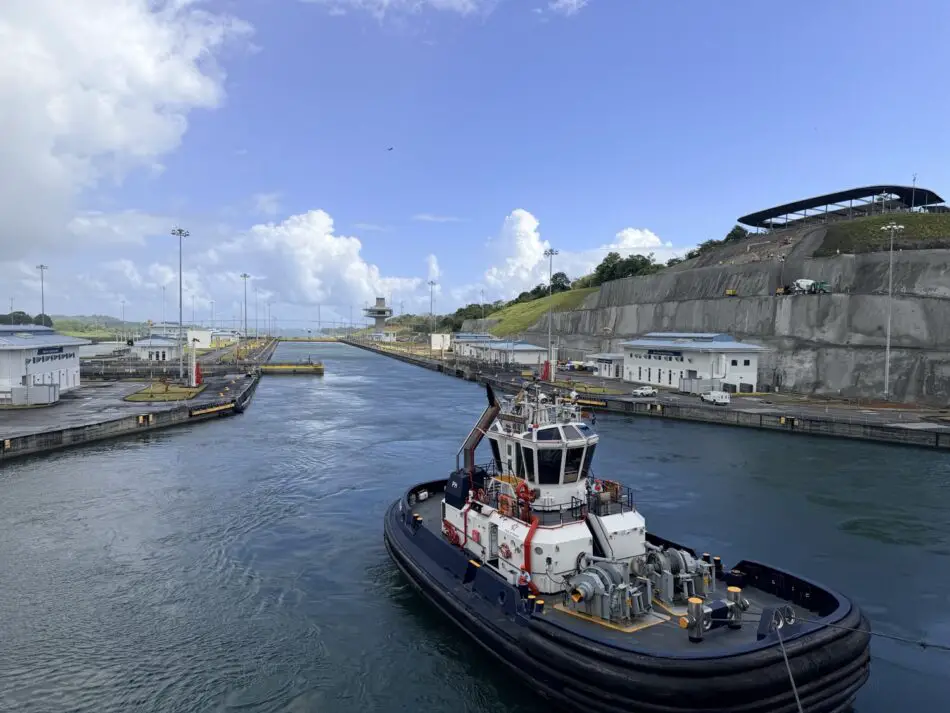 Tugboat in a canal lock beside port facilities