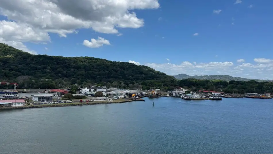 Harbor town with waterfront buildings and green hills