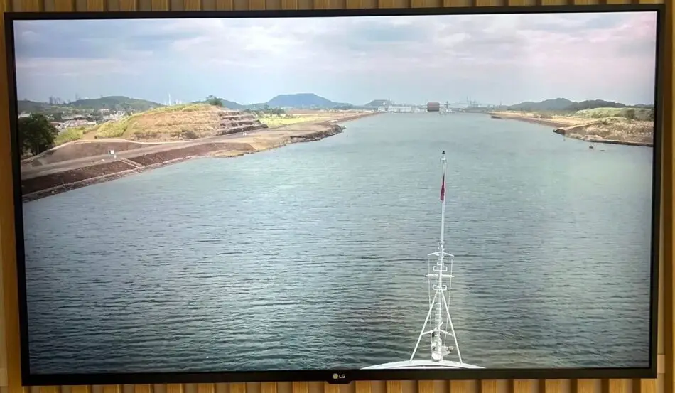 View from the ship's bow down a wide river with land on both shores