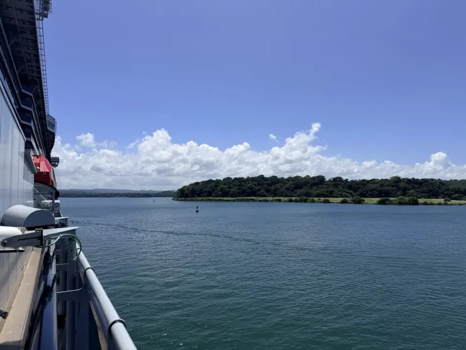 Deck view from a Virgin Voyages cruise ship with blue sea and distant island