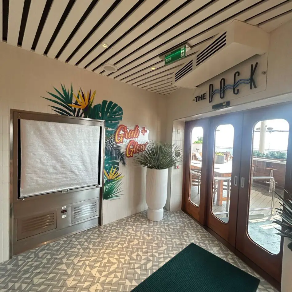 The Dock entrance on a Virgin Voyages cruise ship with glass doors