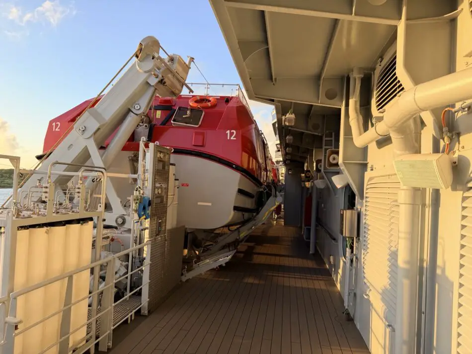 Red lifeboat secured to a cruise ship deck