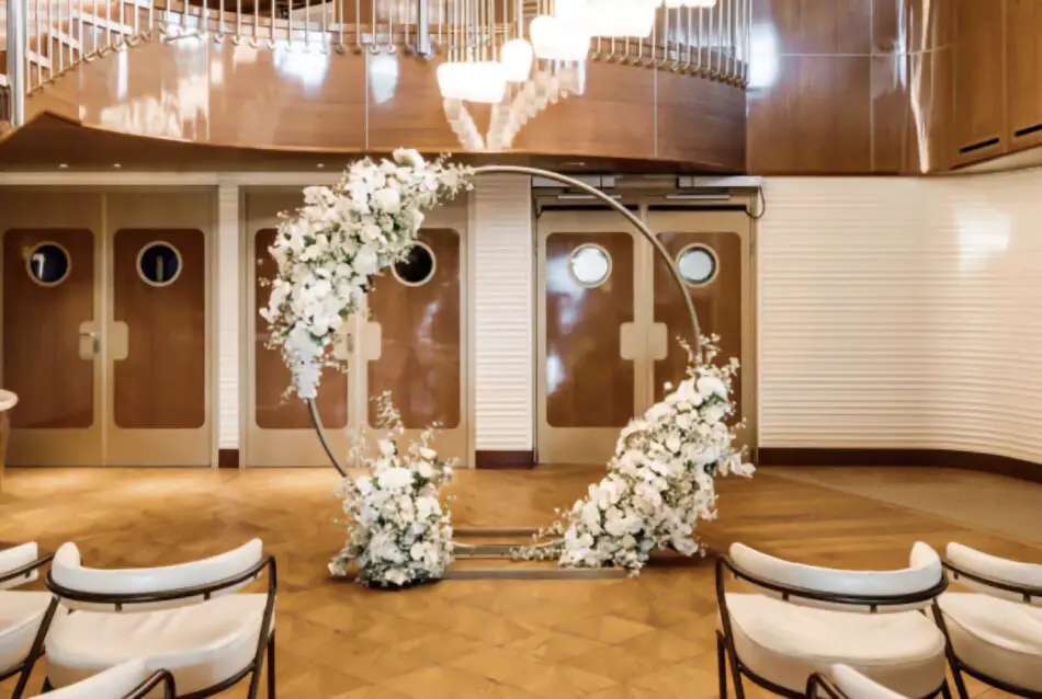 White floral circular arch decorates a cruise ship event space