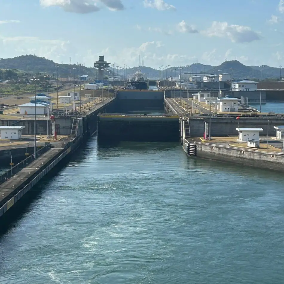 Large canal lock with gates, waterway, and surrounding industrial buildings